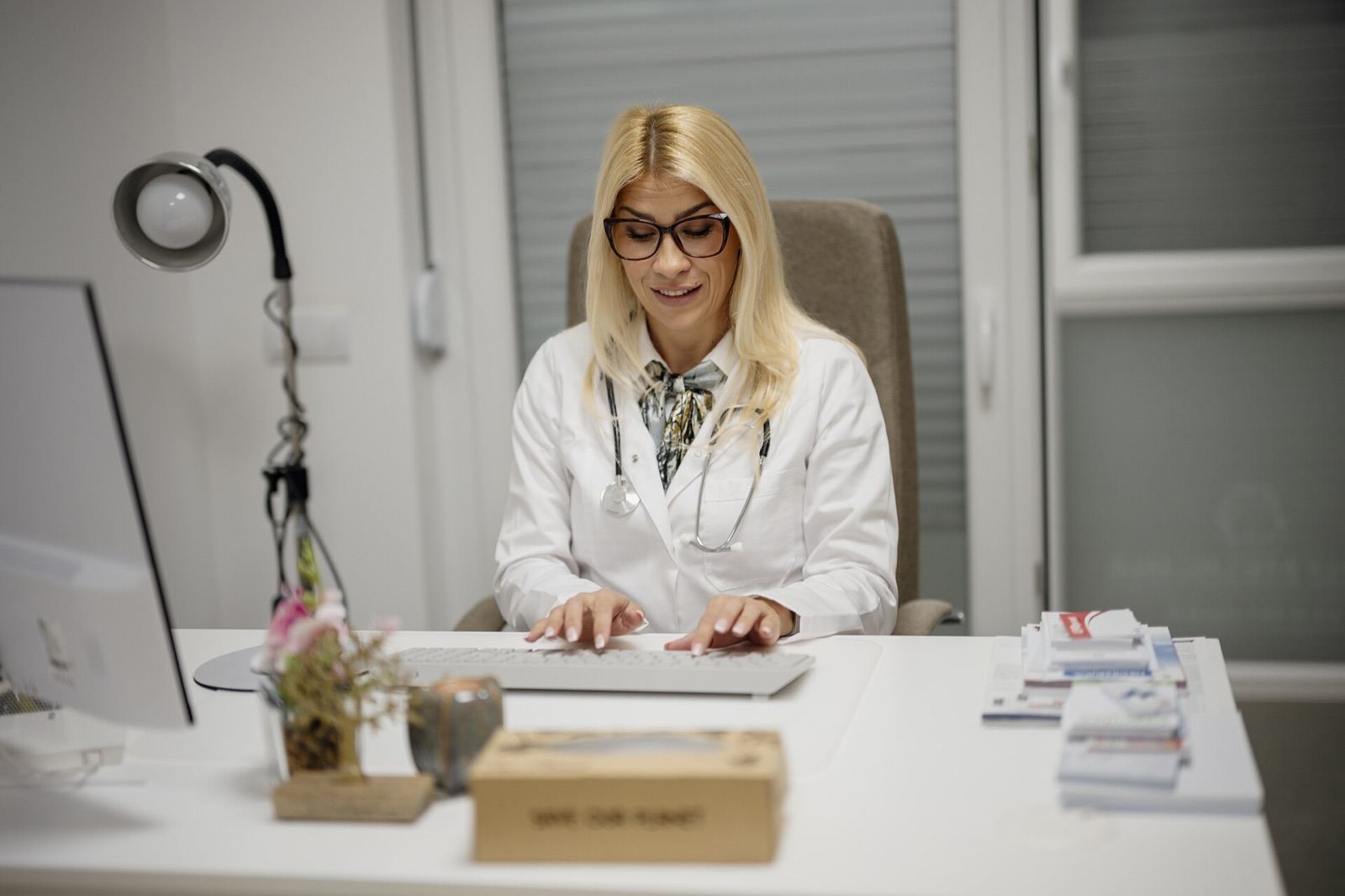 A doctor taking notes during a consultation