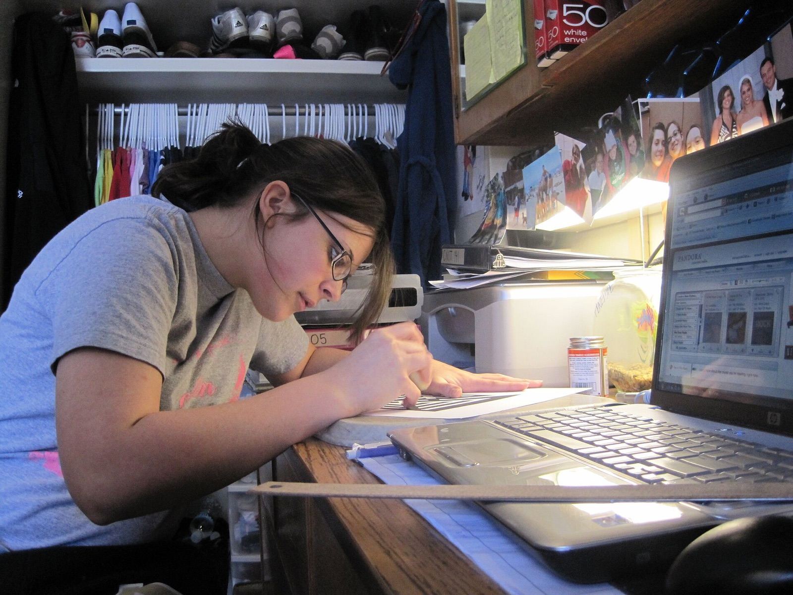 A student studying and writing at her desk
